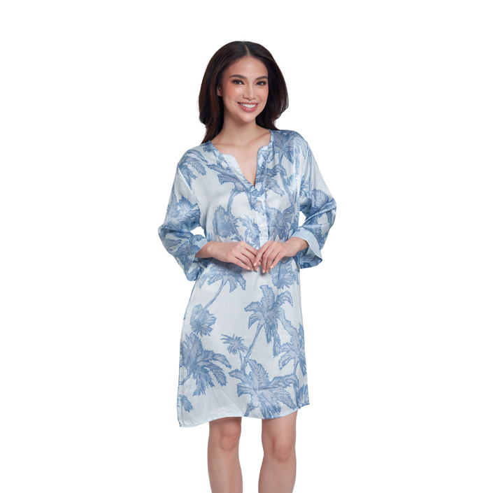 A woman modeling a light blue and white tropical floral print kimono-style dress against a plain white background.