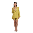 A woman modeling a bright yellow double-breasted blazer and matching shorts set, paired with nude heels, against a plain white background.