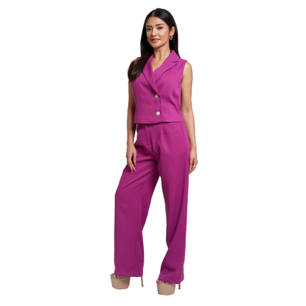 A woman modeling a bright magenta two-piece suit set consisting of a sleeveless blazer-style vest with front buttons and matching wide-leg trousers, shown against a plain white background.