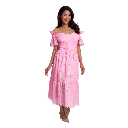 A woman modeling a pink off-the-shoulder eyelet midi dress with tiered ruffle sleeves and a flared skirt, photographed against a plain white studio background.