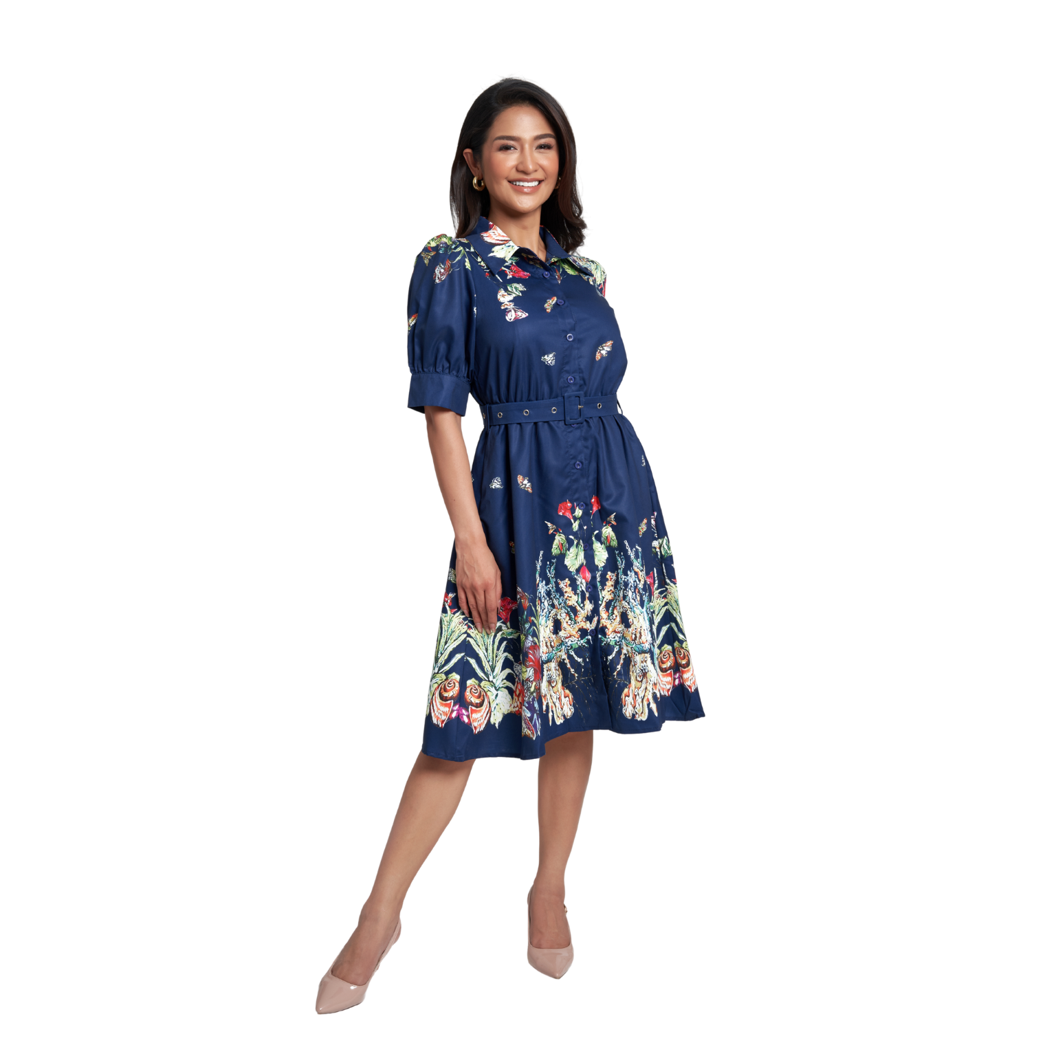 A woman modeling a navy blue midi dress with colorful floral and butterfly patterns, featuring puff sleeves, a button-up front, and a tie waist, set against a plain white background.